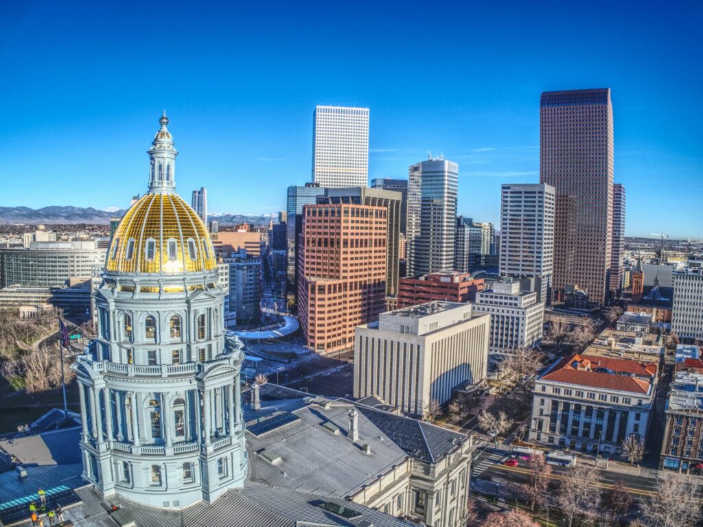 A close up of downtown Denver's skyline thta includes the Capital building